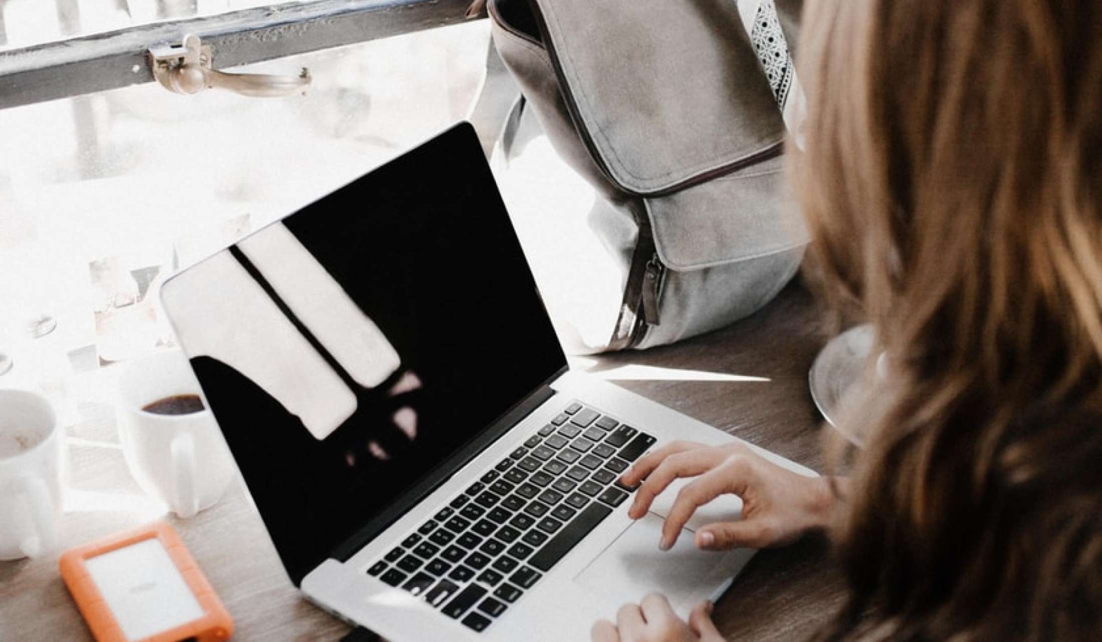 Woman working on a laptop in a coffee shop